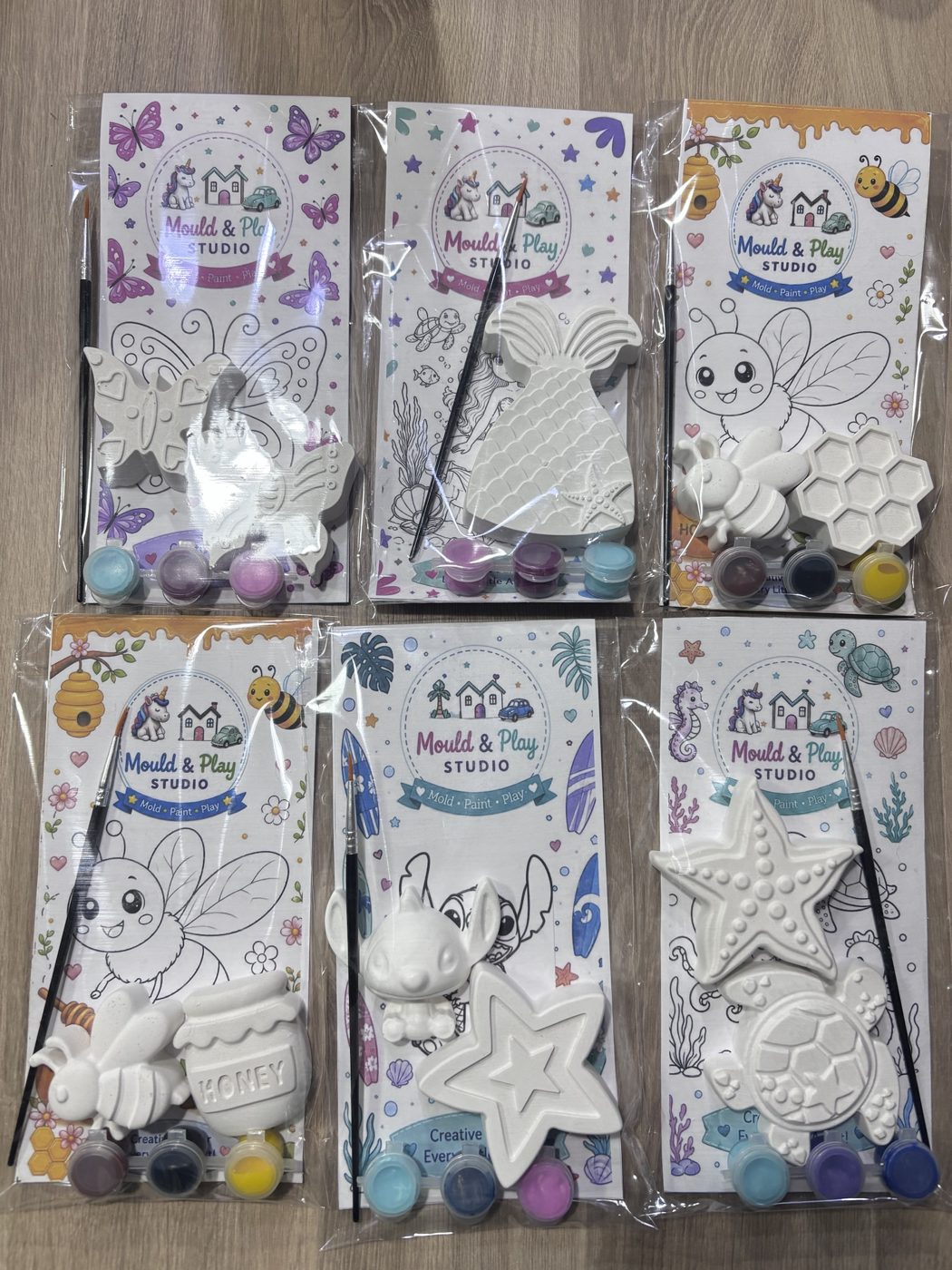 Kids DIY paint kits with plaster figures, paints and colour-in cards